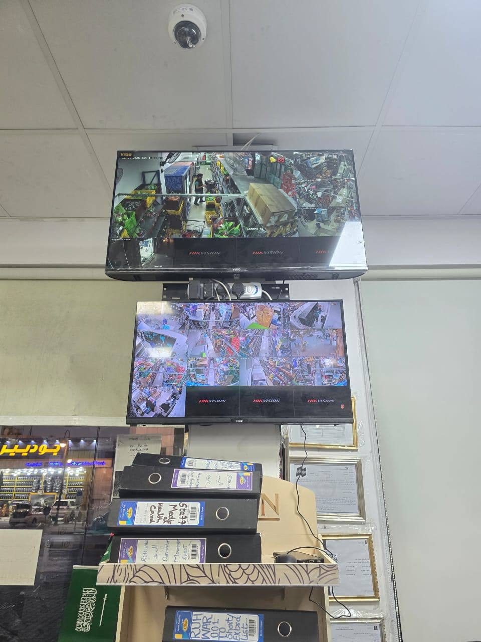 CCTV monitor wall showing live camera feeds